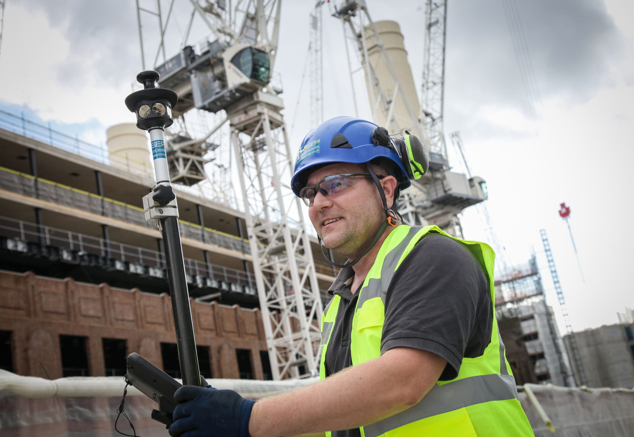 Setting out engineer working on site layout in Kingston